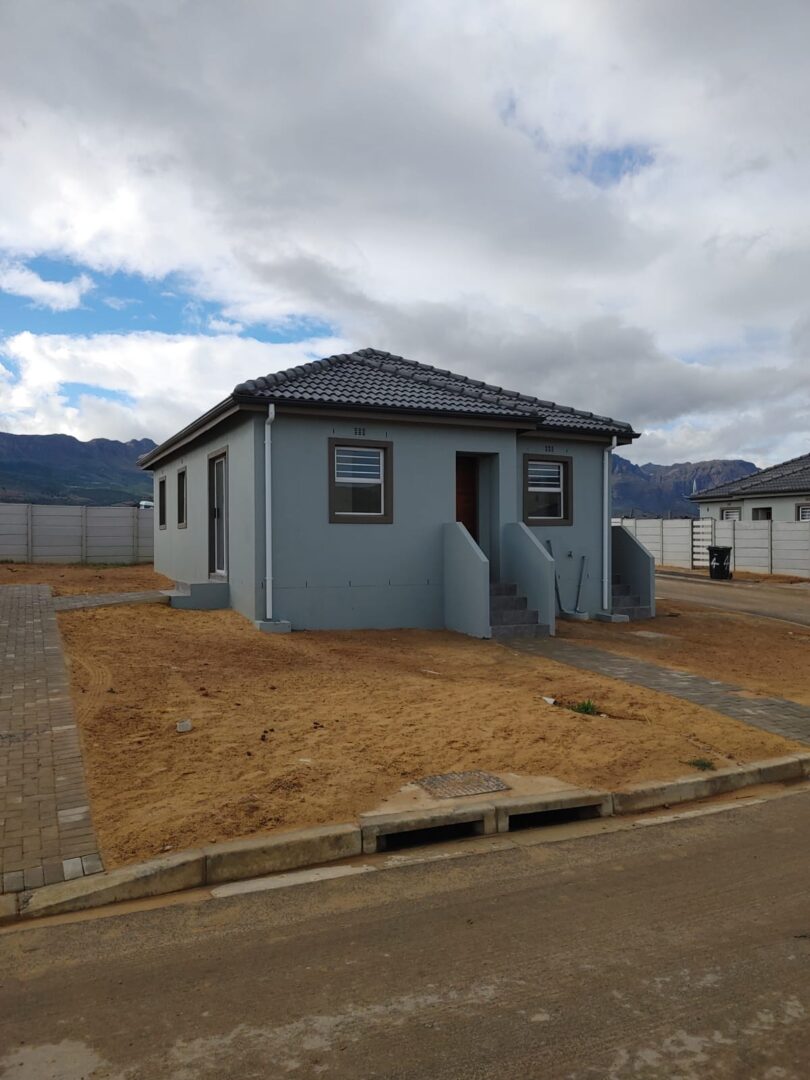 Grey home with stairs to wooden front door in Paarl