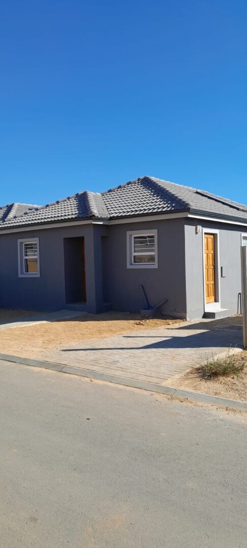 Grey home with wooden door constructed in Paarl